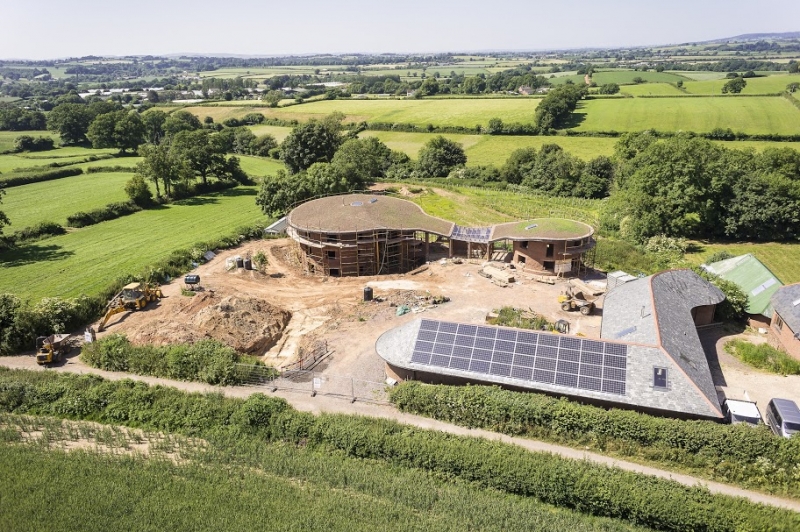 Natural building: dingle dell full site image, solar panels on cob home